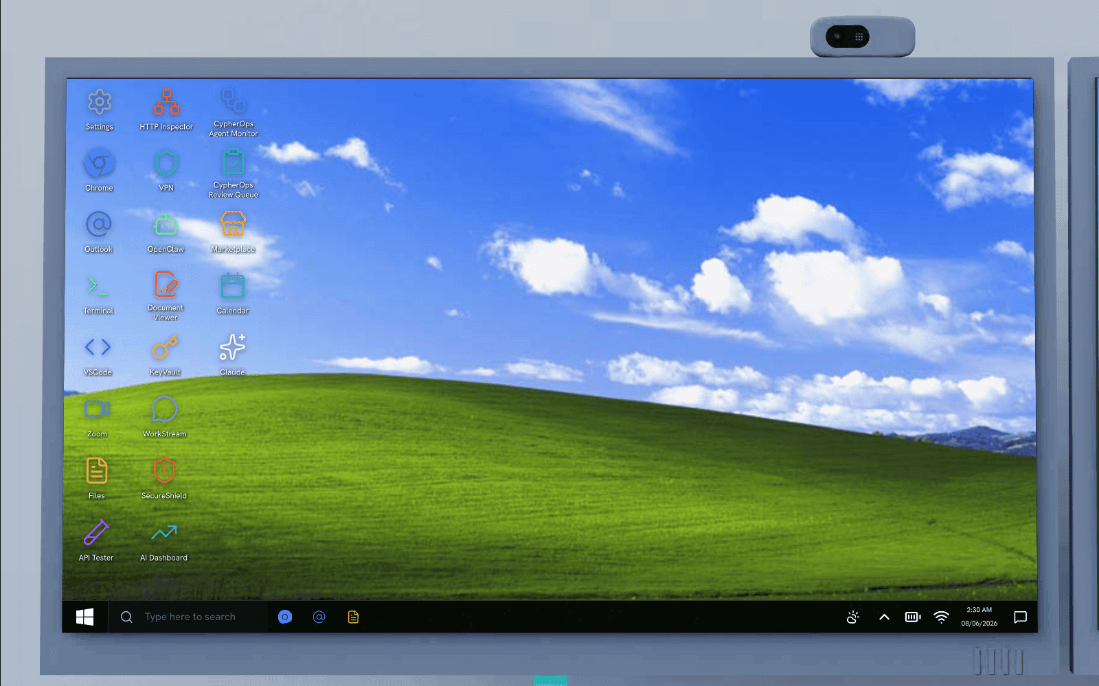 The simulated Windows desktop on the 3D monitor inside the scene, a full desktop with app icons and a taskbar, the same kind of workspace the attack plays out on